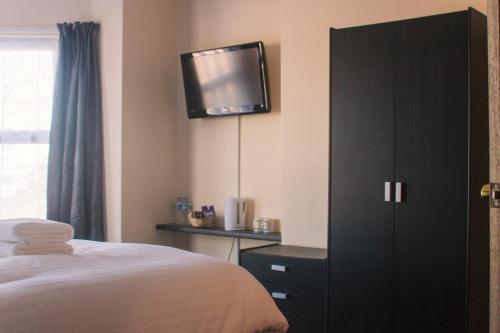 Ένα ή περισσότερα κρεβάτια σε δωμάτιο στο Wellesley Park Hotel