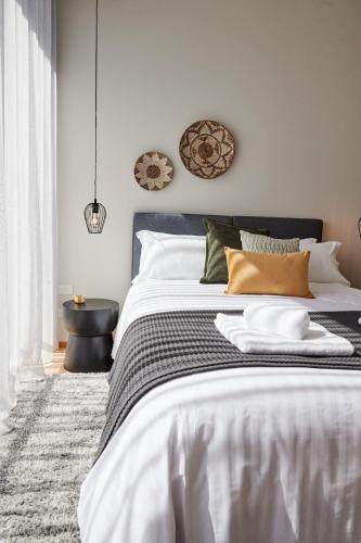 a bedroom with a bed with a black and white comforter at Jacquina - Yarra Valley in Healesville