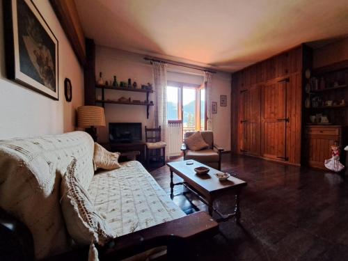 a living room with a couch and a coffee table at Monolocale Pescasseroli Residence Palace in Pescasseroli