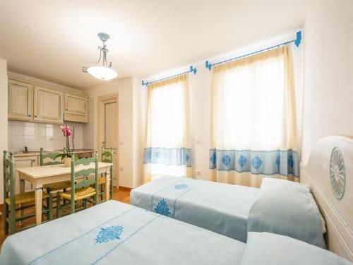 a hospital room with two beds and a table at Apartment in Orosei near Marina di Orosei Beach in Orosei