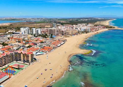 an aerial view of a beach and the ocean at Chalet en La Mata a 50 metros de la playa in Torrevieja