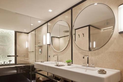a bathroom with a sink and a large mirror at Bvlgari Hotel Paris in Paris