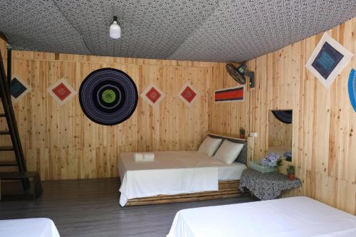 a room with two beds and a target on the wall at Sapa Retreat Homestay & Restaurant in Lao Cai
