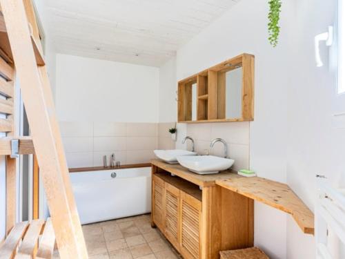 a bathroom with a sink and a bath tub at Maison familiale avec piscine pour 9 personnes - FR-1-835-4 in Le Bois-Plage-en-Ré