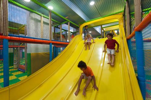 a group of children playing on a slide at a playground at Diar Lemdina Hotel in Hammamet