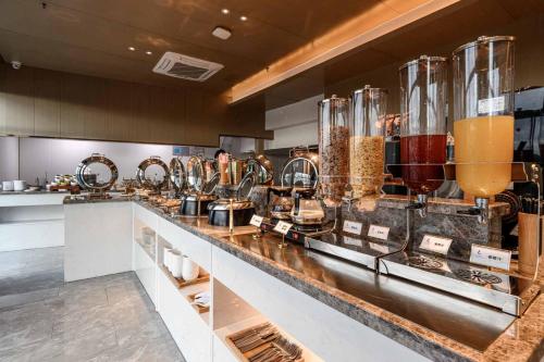 a kitchen with a counter with many different types of food at Lavande Hotel Dongguan Songshan Lake in Dongguan