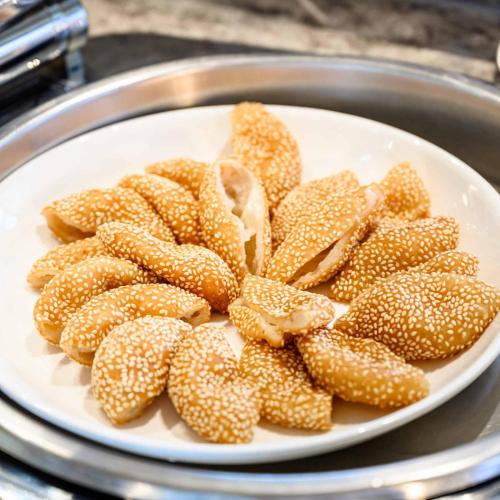 a white plate with a pile of seeded food at Lavande Hotel Dongguan Songshan Lake in Dongguan