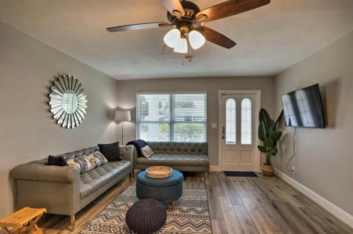 a living room with a couch and a ceiling fan at Hot tub Playground Ping-pong Near beaches! in Largo