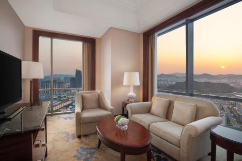 a living room with a view of a city at Shangri-La Suzhou in Suzhou