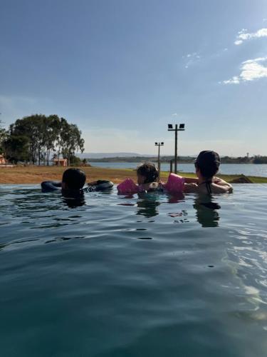 a group of people swimming in the water at Casa de Campo Paraíso na canastra in Delfinópolis
