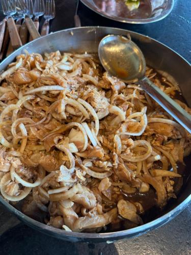 a pan full of food with a spoon in it at Casa de Campo Paraíso na canastra in Delfinópolis