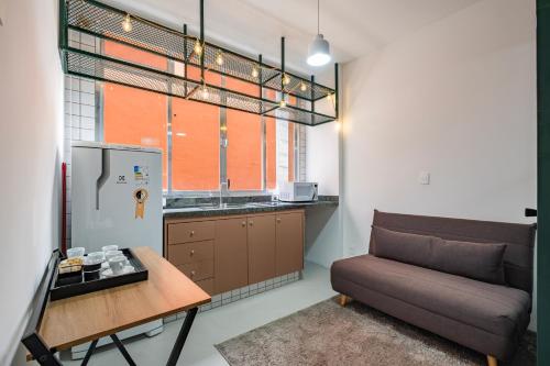 a living room with a couch and a table at Apartamentos inCircle in Sao Paulo