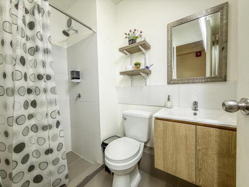a bathroom with a toilet and a sink and a mirror at Nuevo Exclusivo con vista panoramica al mar - Ocean View in Lima