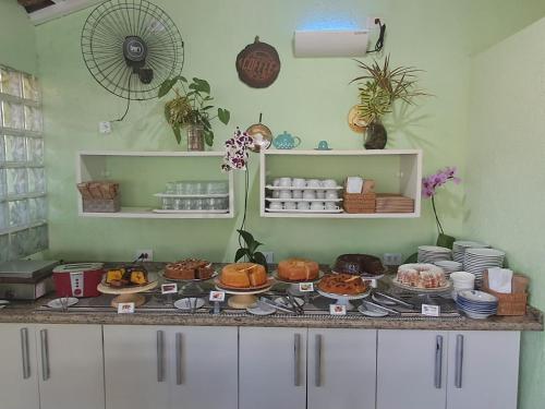 a counter with various food items on a table at Pousada Canto da Ilha in Ilha Comprida