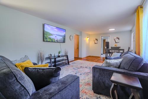 a living room with two couches and a tv at Charming 2 Bed Room in Cleveland in Cleveland Heights