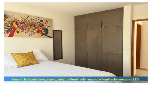 a bedroom with a bed and a wooden cabinet at AdyHouse Tres Cantos in Cedro