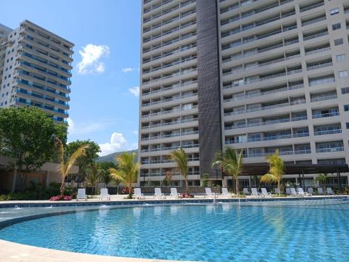a swimming pool in front of two tall buildings at Un Espacio para soñar in Santa Marta