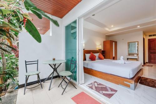 a bedroom in a villa with a bed and a table at C199 Condo 1BR Walk to Lake, Beach, Bars & Market in Rawai Beach