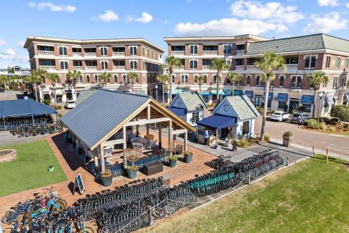 an aerial view of a building with tables and chairs at Sand Pointe by 30A Escapes in Inlet Beach