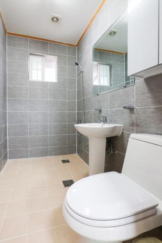 a bathroom with a toilet and a sink at Hongcheon Oullim Glamping Pension in Hongcheon