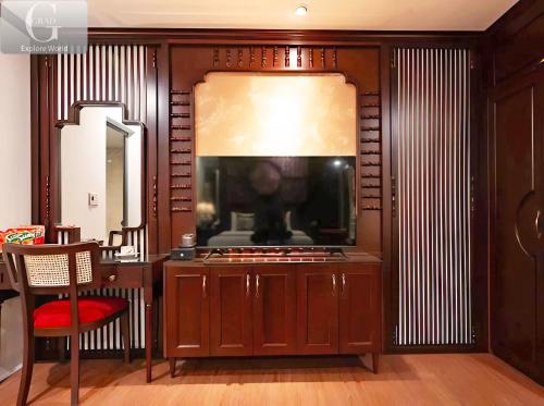 a living room with a fish tank on a wall at Queen Luxury Hotel in Hanoi