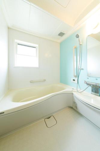 a white bathroom with a tub and a sink at Peaceful Garden Home in Ota, Entire 3BR Parking in Ota