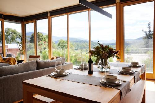 a living room with a table and a couch at Pandora - Yarra Valley in Healesville