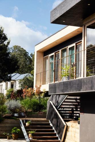 a house with a staircase in front of it at Pandora - Yarra Valley in Healesville