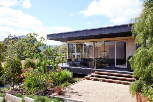 a modern house with a black roof at Pandora - Yarra Valley in Healesville