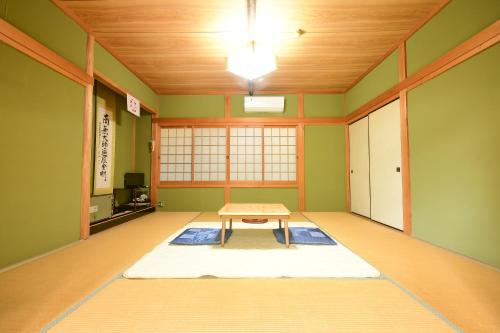 a room with a table in the middle of a room at 高野山 宿坊 光明院 -Koyasan Shukubo Komyoin- in Koyasan