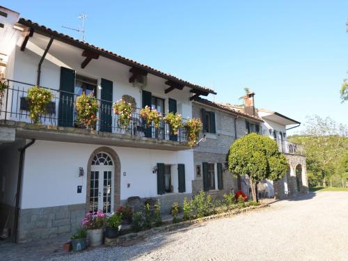 a building with flower boxes on the balconies at Apartment in quiet and green environment with swimming pool in Modigliana