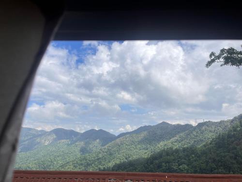 a view of a mountain range from a window at TEC Resort and bar in Dharān Bāzār