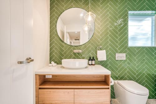 a bathroom with a sink and a mirror at Essence Peregian Beach in Peregian Beach