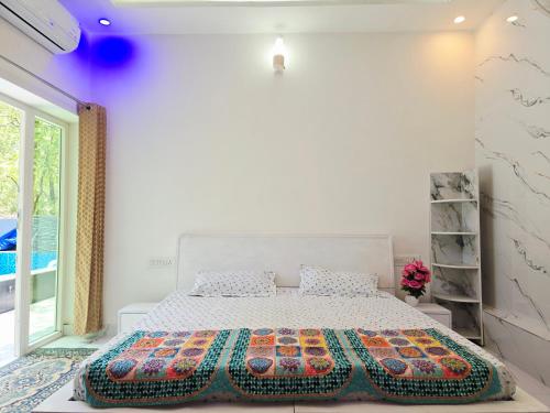 a bedroom with a bed with a colorful blanket on it at Forest Retreat Khalanga in Rāipur