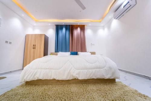AshaimanにあるModern Comfort Tema/beach Proximityのベッドルーム1室(大型ベッド1台、ラグ付)