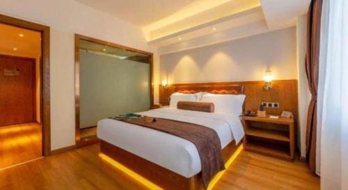 a hotel room with a large bed and a window at James Joyce Coffetel Kunming Railway Station Huancheng Nan Road Metro Station in Kunming