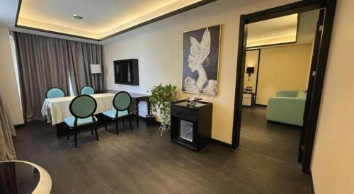a hotel room with a table and chairs and a fireplace at Xana Hotelle Jinan Wuanfu Interchange Huafu International Square in Jinan