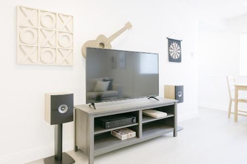 a living room with a flat screen tv and speakers at 2BR APT with Brand new super quite AC, Washer, Dryer, Free EV Station, Free Parking in Cupertino in Sunnyvale
