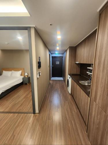 a hotel room with a bed and a kitchen at Elbon the stay with A1 in Busan