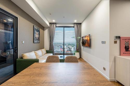 a living room with a table and a couch at LUMIERE RIVERSIDE LUXURY APARTMENT 5STar in Ho Chi Minh City