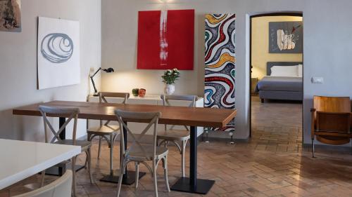 a dining room with a table and chairs and a bed at Relais Della Corte in Sala Baganza