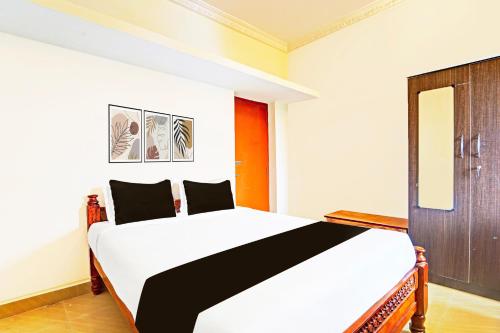 Ένα ή περισσότερα κρεβάτια σε δωμάτιο στο Super Hotel O Chidambaram City Centre