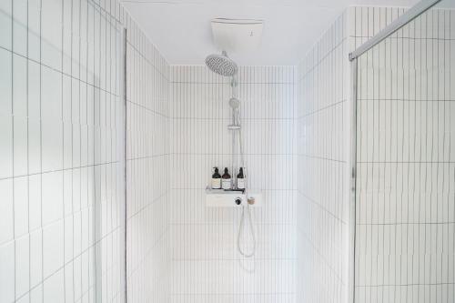 a bathroom with a shower with a shower head at Sokcho Mari Vista Hotel in Sokcho