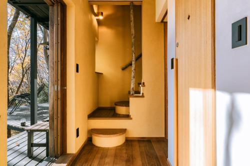 a hallway of a house with yellow walls at COCO VILLA 長瀞-Sauna- in Nagatoro