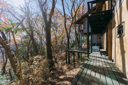 a wooden walkway leading up to the side of a house at COCO VILLA 長瀞-Sauna- in Nagatoro