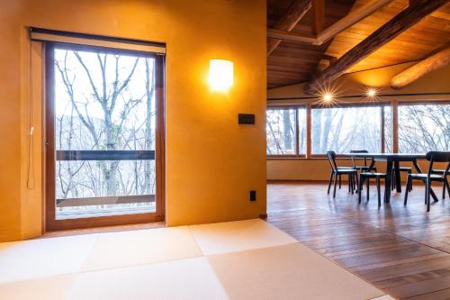 a dining room with a table and chairs at COCO VILLA 長瀞-Sauna- in Nagatoro