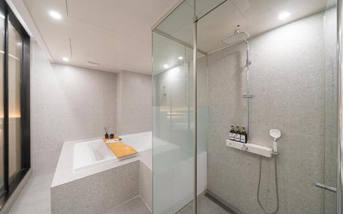 a bathroom with a shower with a glass door at Incheon BrownDot Hotel Guwol in Incheon