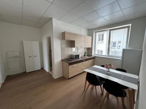 a kitchen with a table and chairs in a room at Škodova Apartments in Přerov