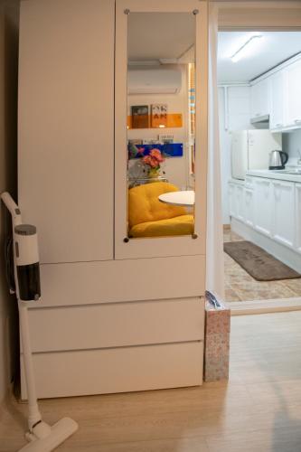 a room with a sliding door with a yellow couch at Coco Bloom Sinsa in Seoul