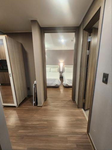 a hallway with two beds in a room at Elbon the stay with A1 in Busan